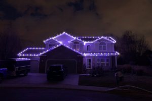 Purple and white Christmas Lights on house